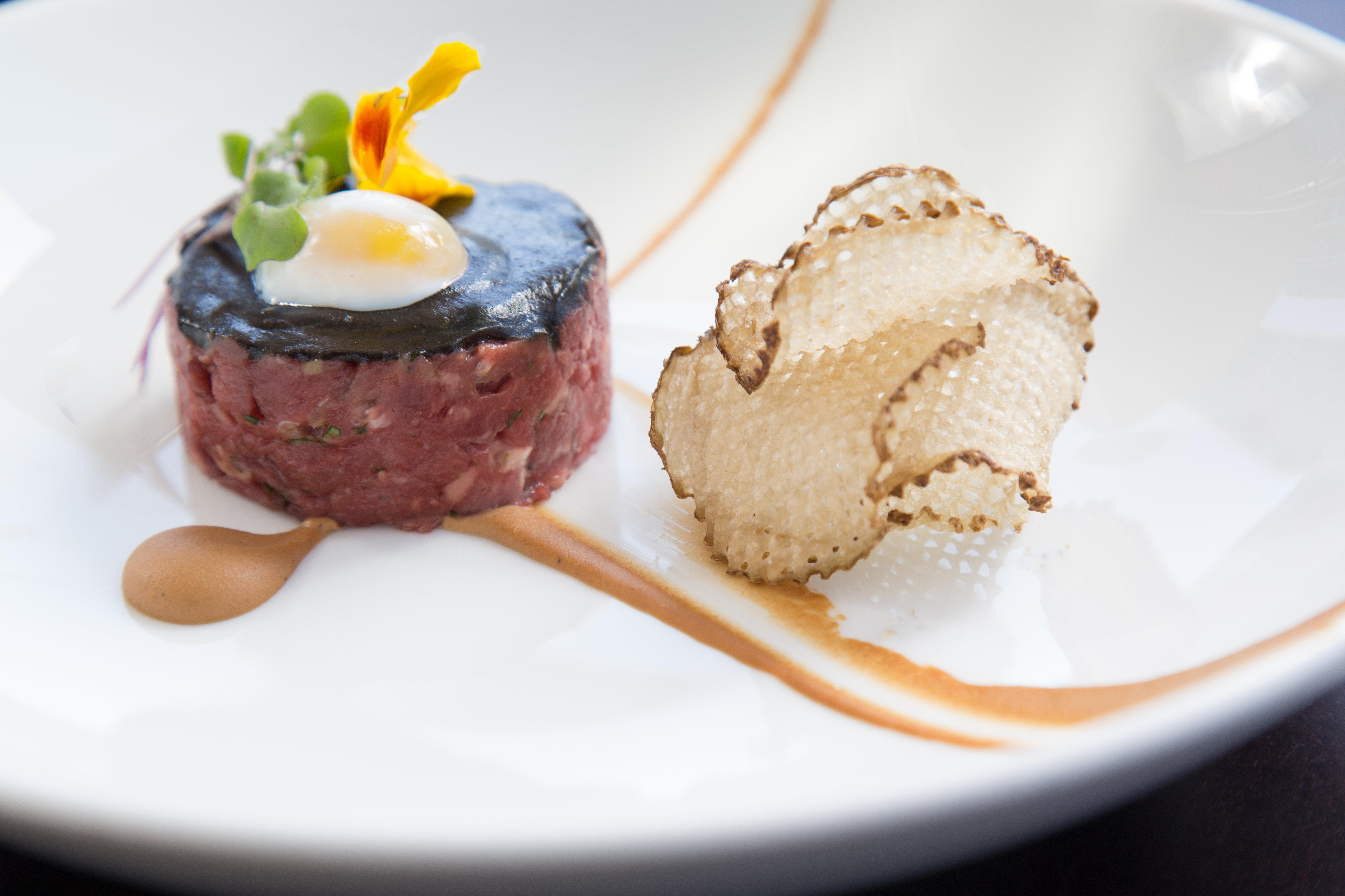 Kimpton Epic Hotel By Ihg Miami Bagian luar foto A dish of beef tartar with a slice of black truffle